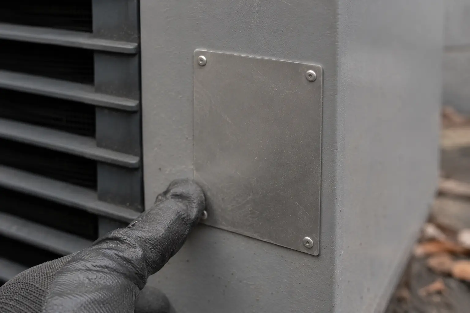 Blank rating plate on the side panel of a heat pump outdoor unit
