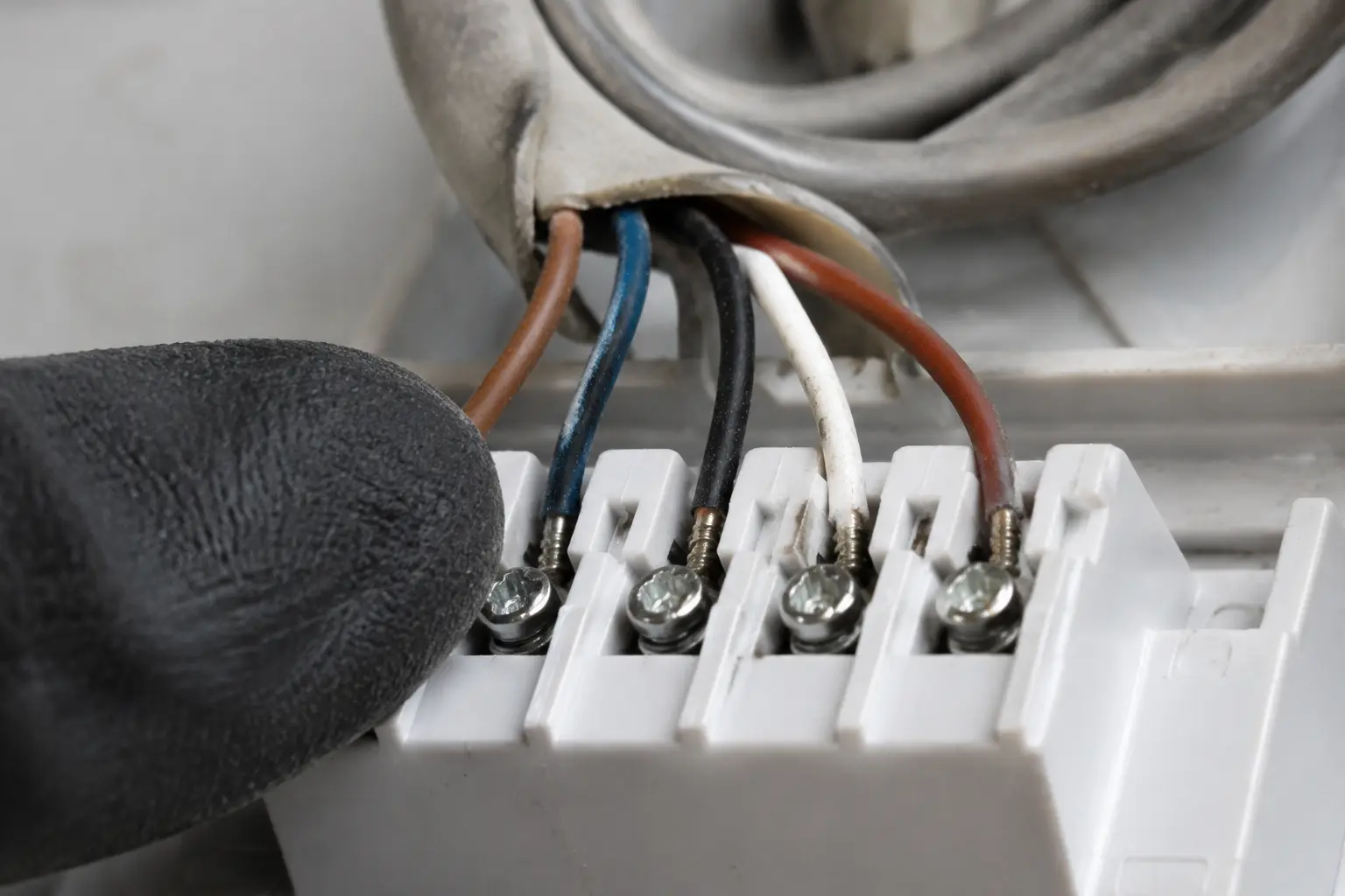 Low voltage conductors landed on a heat pump thermostat sub-base