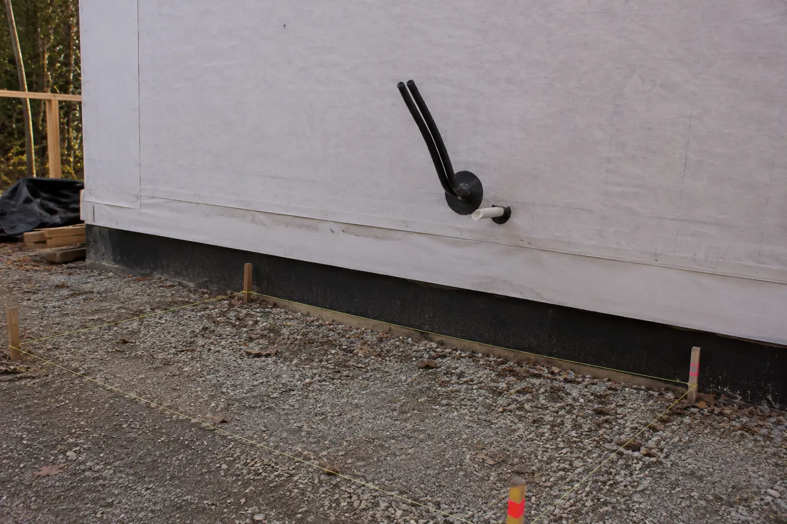 Line set and condensate stub-outs through a sheathed exterior wall on a new build