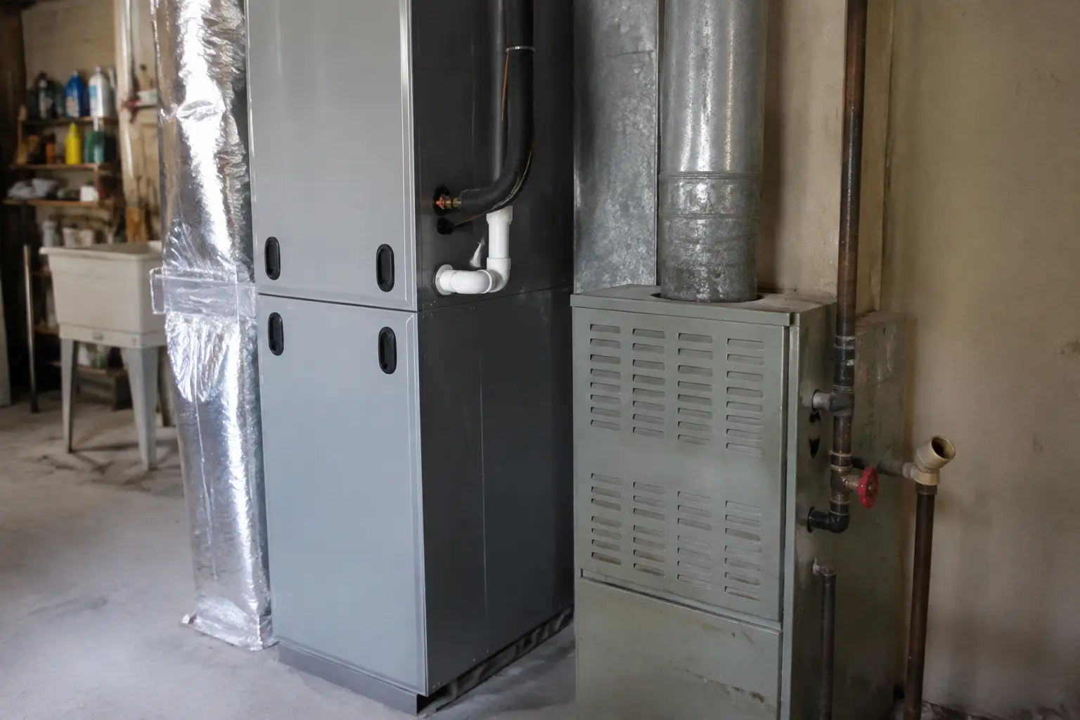 Propane furnace disconnected beside a new heat pump air handler