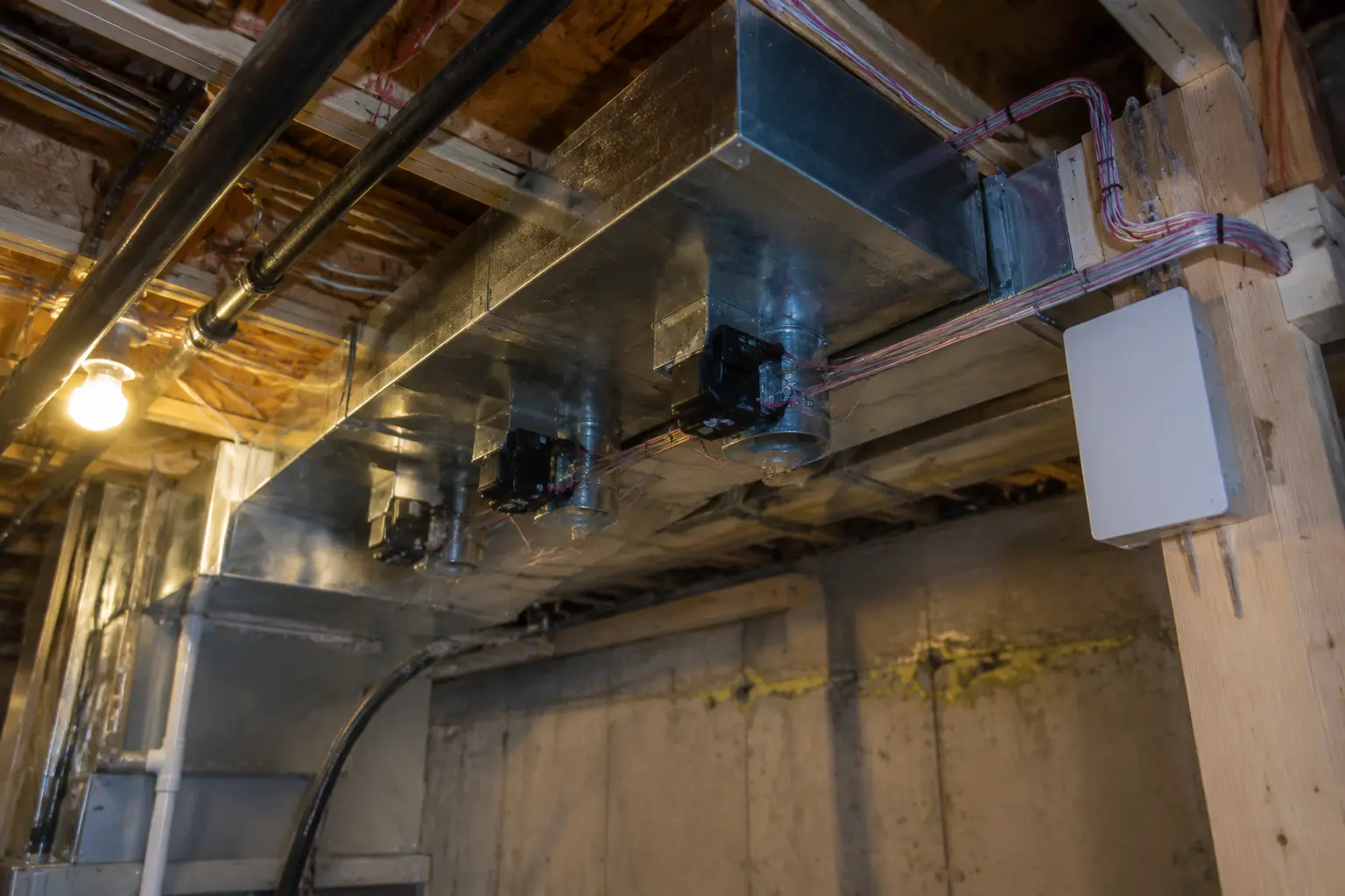 Zoning dampers and control wiring on a heat pump supply trunk