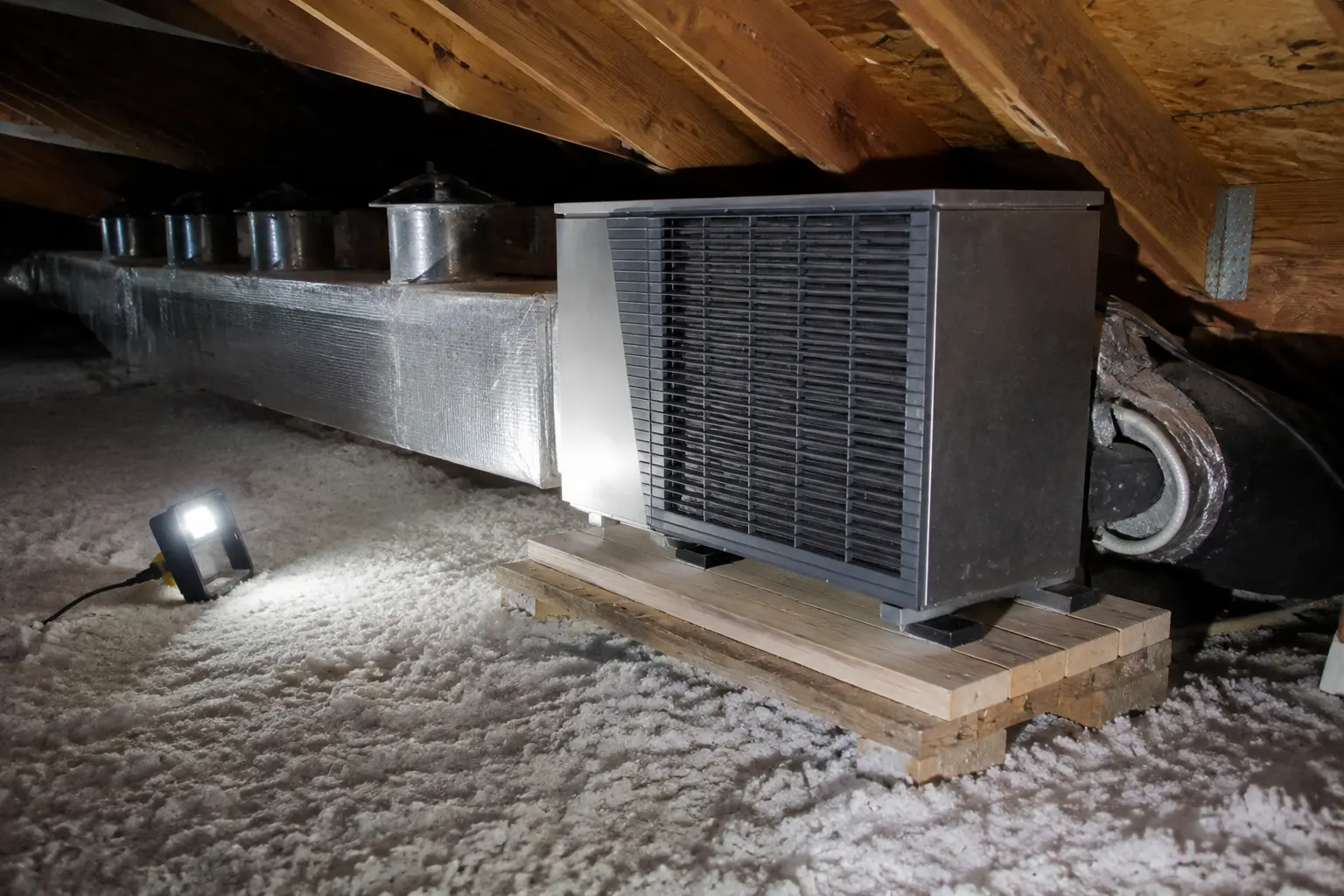 Ducted heat pump air handler and insulated trunk duct in a Spokane attic
